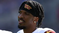 Jayden Daniels #5 of the Washington Commanders and quarterback Marcus Mariota #18 of the Washington Commanders look on against the Baltimore Ravens during the first half at M&T Bank Stadium on October 13, 2024 in Baltimore, Maryland.
