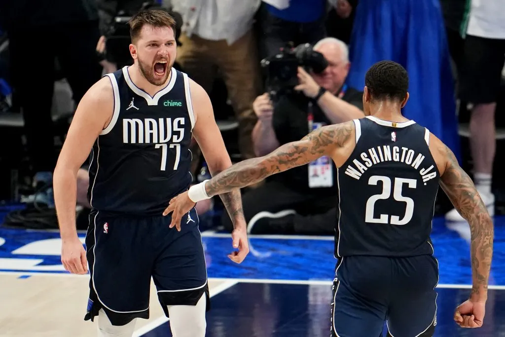 DALLAS, TEXAS – MAY 26: Luka Doncic #77 and P.J. Washington #25 of the Dallas Mavericks celebrate during the final minute of the fourth quarter against the Minnesota Timberwolves. Cooper Neill/Getty Images