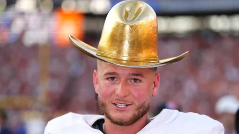 Quinn Ewers #3 of the Texas Longhorns wears the Golden Hat Trophy after defeating the Oklahoma Sooners 34-3 at Cotton Bowl Stadium on October 12, 2024 in Dallas, Texas.