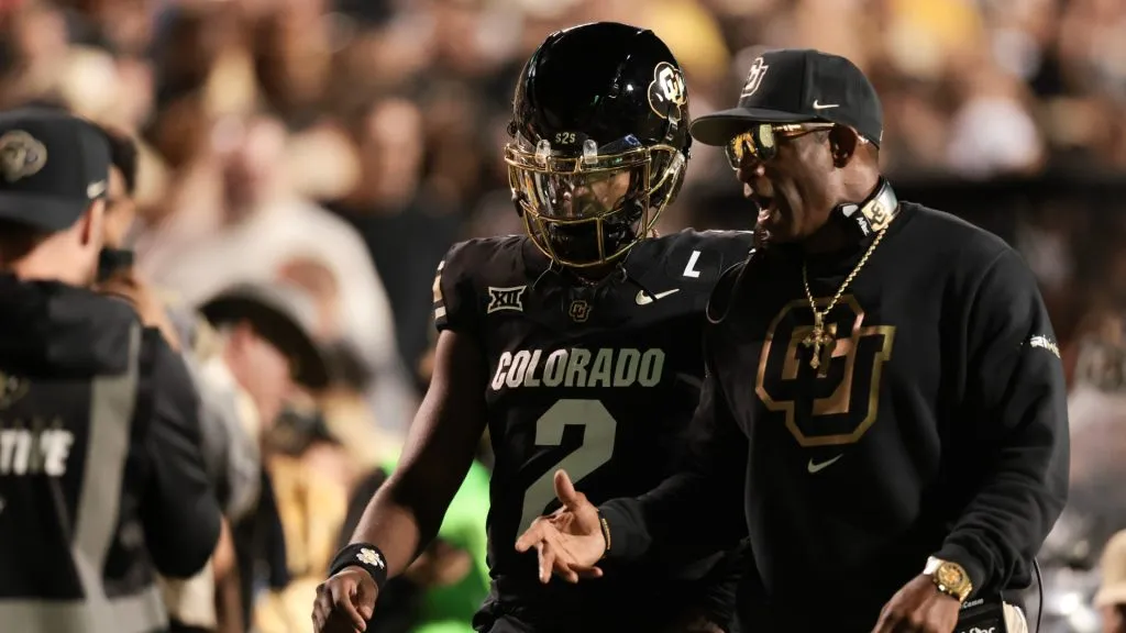 Shedeur Sanders #2 and head coach Deion Sanders of the Colorado Buffaloes walk the sidelines prior to the game against the Kansas State Wildcats at Folsom Field on October 12, 2024 in Boulder, Colorado.