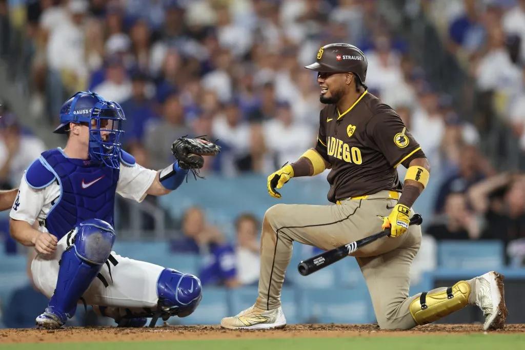 Luis Arraez #4 of the San Diego Padres reacts in front of Will Smith #16 of the Los Angeles Dodgers after a high pitch during the sixth inning of Game Five of the Division Series at Dodger Stadium on October 11, 2024 in Los Angeles, California.  (Photo by Sean M. Haffey/Getty Images)