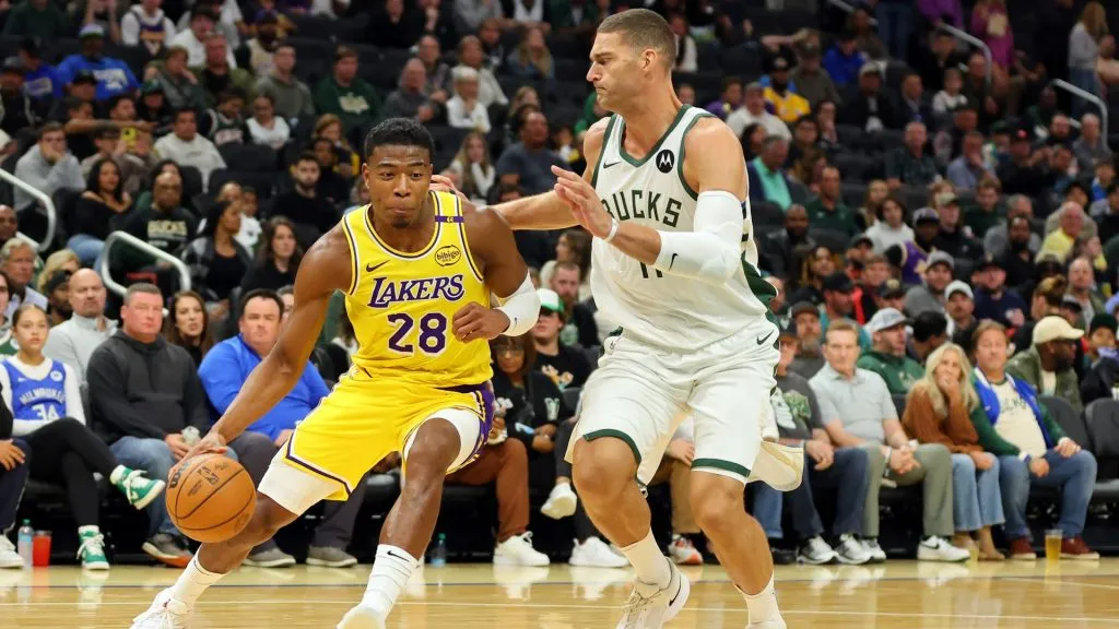 Rui Hachimura #28 of the Los Angeles Lakers works against Brook Lopez #11 of the Milwaukee Bucks during a preseason game at Fiserv Forum on October 10, 2024 in Milwaukee, Wisconsin.