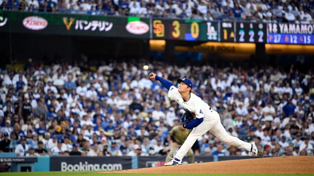 Yoshinobu Yamamoto #18 of the Los Angeles Dodgers throws a pitch during the first inning against the San Diego Padres in Game One of the Division Series at Dodger Stadium on October 05, 2024 in Los Angeles, California. (Photo by Orlando Ramirez/Getty Images)