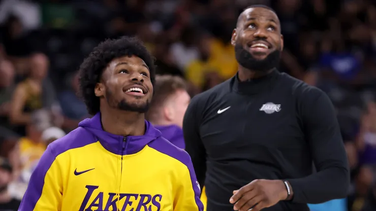 Bronny James #9 and LeBron James #23 of the Los Angeles Lakers look on during warm ups prior to the game against the Phoenix Suns at Acrisure Arena on October 06, 2024 in Palm Springs, California.