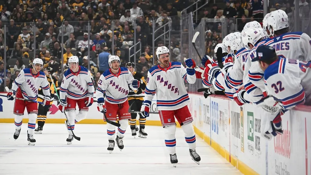 Sam Carrick #39 of the New York Rangers celebrates with teammates on the bench after scoring a goal in the first period of the Pittsburgh Penguins home opener at PPG PAINTS Arena on October 9, 2024 in Pittsburgh, Pennsylvania. (Photo by Justin Berl/Getty Images)