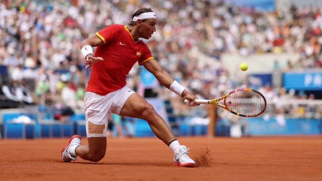 Rafael Nadal of Team Spain plays a backhand against Marton Fucsovics of Team Hungary during the Men’s Singles first round match on day two of the Olympic Games Paris 2024 at Roland Garros on July 28, 2024 in Paris, France. (Photo by Clive Brunskill/Getty Images)