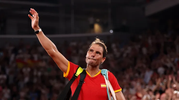 Rafael Nadal of Team Spain acknowledges the crowd as he leaves the court with partner (out of frame) Carlos Alcaraz of Team Spain after their Men's Doubles Quarter-final match against Austin Krajicek of Team United States and Rajeev Ram of Team United States on day five of the Olympic Games Paris 2024 at Roland Garros on July 31, 2024 in Paris, France.