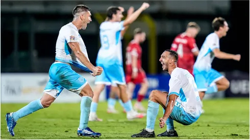 Players of San Marino celebrate their historical first victory in official match