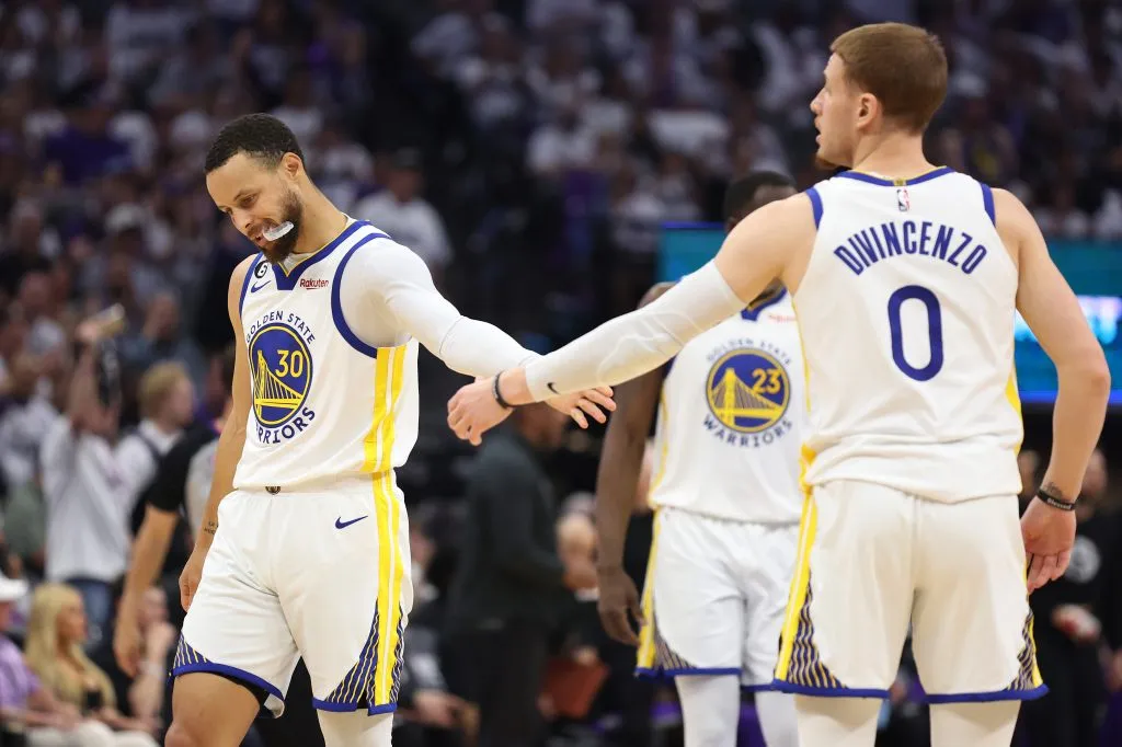 Stephen Curry #30 of the Golden State Warriors high fives Donte DiVincenzo #0 during the second quarter against the Sacramento Kings. Ezra Shaw/Getty Images