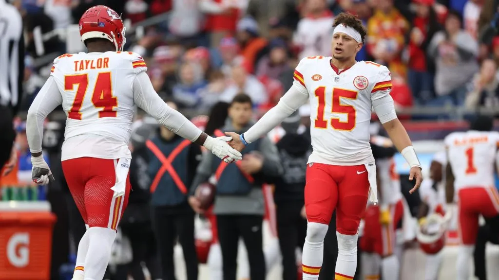 Patrick Mahomes #15 of the Kansas City Chiefs high fives Jawaan Taylor #74 of the Kansas City Chiefs during the third quarter against the New England Patriots at Gillette Stadium on December 17, 2023 in Foxborough, Massachusetts.