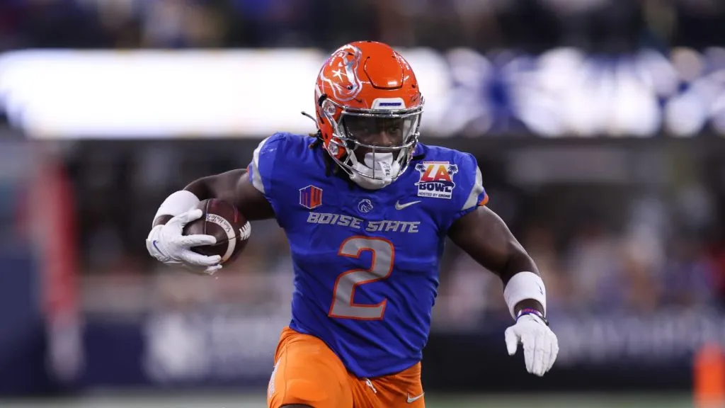 Boise State running back ASHTON JEANTY (2) runs with the ball while being tackled by UCLA linebacker DARIUS MUASAU (53) during the 2023 Starco Brands LA Bowl Hosted by Gronk between UCLA and Boise State at SoFi Stadium in Los Angeles, California.
