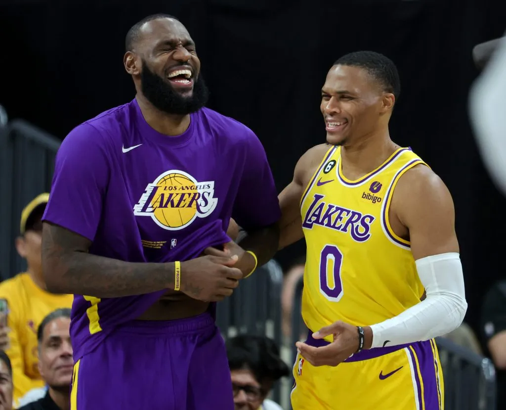 LeBron James #6 and Russell Westbrook #0 of the Los Angeles Lakers laugh on the sideline. Ethan Miller/Getty Images