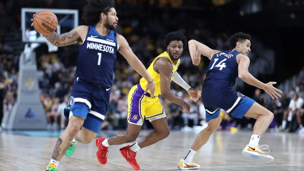 Bronny James #9 of the Los Angeles Lakers defends against Daishen Nix #1 and Jesse Edwards #14 of the Minnesota Timberwolves during the second half of a game at Acrisure Arena on October 04, 2024 in Palm Springs, California.