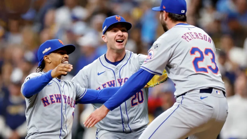 Francisco Lindor #12, Pete Alonso #20, and David Peterson #23 of the New York Mets celebrate after beating the Milwaukee Brewers 4-2 during Game Three of the Wild Card Series at American Family Field on October 03, 2024 in Milwaukee, Wisconsin. (Photo by John Fisher/Getty Images)