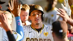 Manny Machado #13 of the San Diego Padres is congratulated after hitting a solo home run during the eighth inning of a baseball game against the Atlanta Braves at Petco Park on July 13, 2024 in San Diego, California.