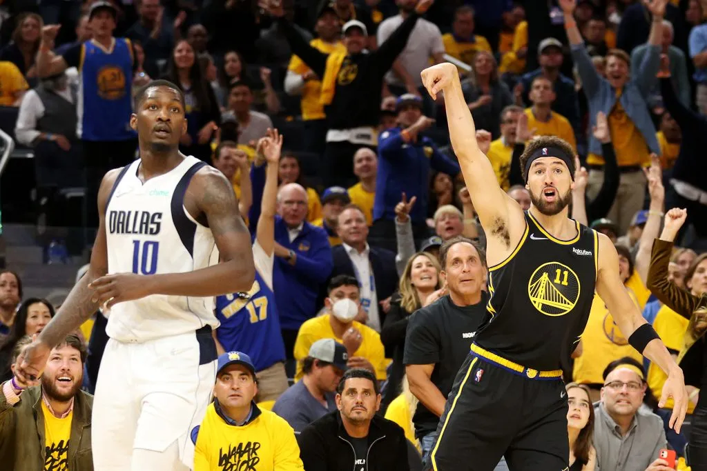 Klay Thompson #11 of the Golden State Warriors reacts after a three point basket during the fourth quarter against Dorian Finney-Smith #10 of the Dallas Mavericks. Ezra Shaw/Getty Images