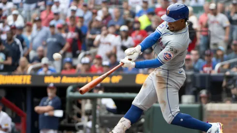 Francisco Lindor #12 of the New York Mets hits a two-run homer to score Starling Marte in the ninth inning of game one of a doubleheader against the Atlanta Braves at Truist Park on September 30, 2024 in Atlanta, Georgia. (Photo by Edward M. Pio Roda/Getty Images)