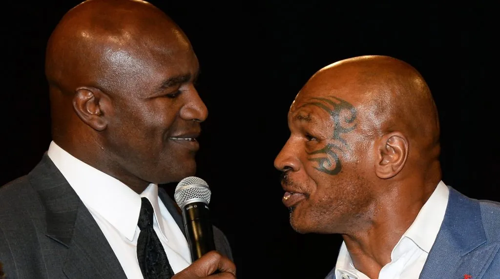 Former boxer Evander Holyfield (L) is inducted into the Nevada Boxing Hall of Fame by former boxer Mike Tyson at the second annual induction gala at the New Tropicana Las Vegas on August 9, 2014 in Las Vegas, Nevada. (Photo by Ethan Miller/Getty Images)
