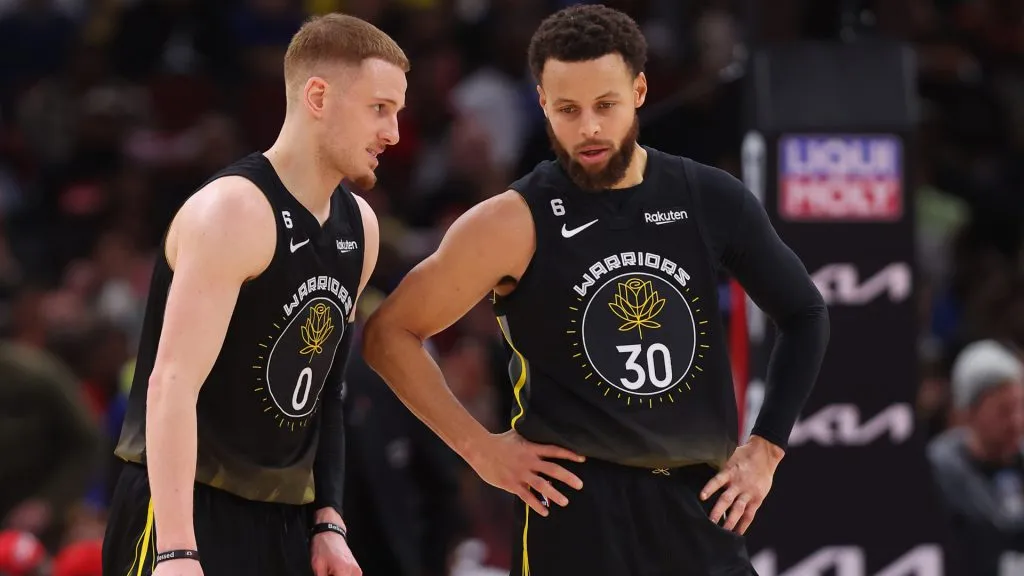 Donte DiVincenzo #0 and Stephen Curry #30 of the Golden State Warriors talk against the Chicago Bulls during the second half at United Center. (Michael Reaves/Getty Images)
