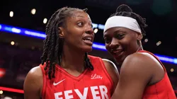 Kelsey Mitchell #0 of the Indiana Fever is held back by Erica Wheeler #17 during the second half against the Phoenix Mercury