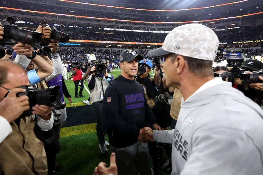 INGLEWOOD, CALIFORNIA – NOVEMBER 25: Head coach John Harbaugh (L) of the Baltimore Ravens shakes hands with his brother head coach Jim Harbaugh (R) of the Los Angeles Chargers after the game at SoFi Stadium on November 25, 2024 in Inglewood, California. (Photo by Sean M. Haffey/Getty Images)