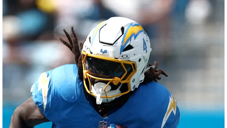 Running back Gus Edwards #4 of the Los Angeles Chargers carries the ball during the first half of the game against the Carolina Panthers at Bank of America Stadium on September 15, 2024 in Charlotte, North Carolina.