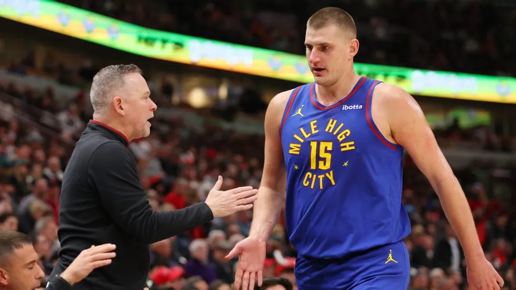 Nikola Jokic #15 of the Denver Nuggets high fives head coach Michael Malone against the Chicago Bulls during the first half at the United Center. (Michael Reaves/Getty Images)
