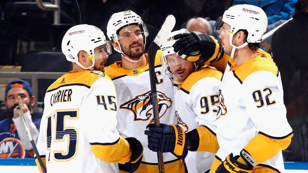 Matt Duchene #95 of the Nashville Predators (2nd from right) celebrates his 300th NHL goal into an empty net at 18:47 of the third period against the New York Islanders at the UBS Arena in 2022. (Source: Bruce Bennett/Getty Images)