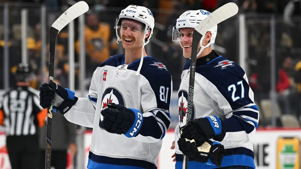 Kyle Connor #81 of the Winnipeg Jets celebrates with Nikolaj Ehlers #27 following a 4-1 win over the Pittsburgh Penguins during the game at PPG PAINTS Arena on November 22, 2024. (Source: Justin Berl/Getty Images)