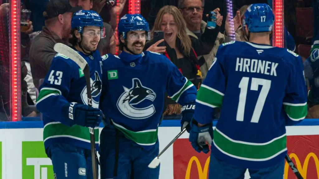 Conor Garland #8 of the Vancouver Canucks celebrates scoring with teammates Quinn Hughes #43 and Filip Hronek #17 against the New York Rangers during the second period on November, 19, 2024. (Source: Rich Lam/Getty Images)