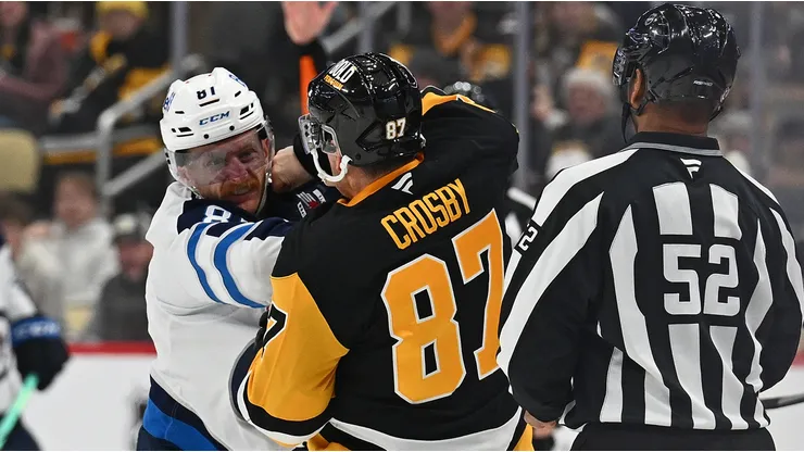 Sidney Crosby #87 of the Pittsburgh Penguins fights Kyle Connor #81 of the Winnipeg Jets in the third period during the game at PPG PAINTS Arena on November 22, 2024 in Pittsburgh, Pennsylvania.