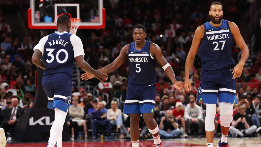 Julius Randle #30, Anthony Edwards #5 and Rudy Gobert #27 of the Minnesota Timberwolves celebrate a basket against the Chicago Bulls during the second half of a preseason game at the United Center. (Michael Reaves/Getty Images)