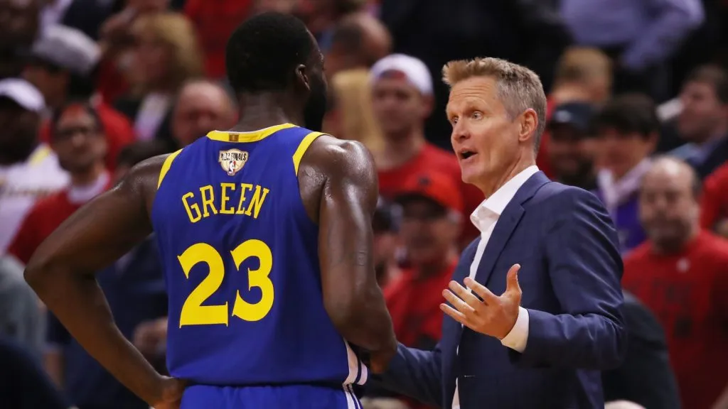 Head coach Steve Kerr of the Golden State Warriors speaks to Draymond Green #23 during a timeout against the Toronto Raptors in the first half during Game Two of the 2019 NBA Finals at Scotiabank Arena on June 02, 2019 in Toronto, Canada.