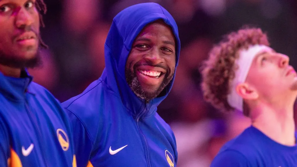 Golden State Warriors forward Draymond Green smiles as he stand with teammates for the national anthem before the first half of between the Golden State Warriors and Los Angeles Clippers in 2023. (Source: IMAGO / Icon Sportswire)