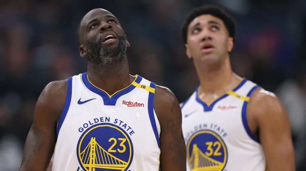 Draymond Green #23 and Trayce Jackson-Davis #32 of the Golden State Warriors look up at a replay during a 102-99 loss to the LA Clippers at Intuit Dome on November 18, 2024 in Inglewood, California. (Photo by Harry How/Getty Images)