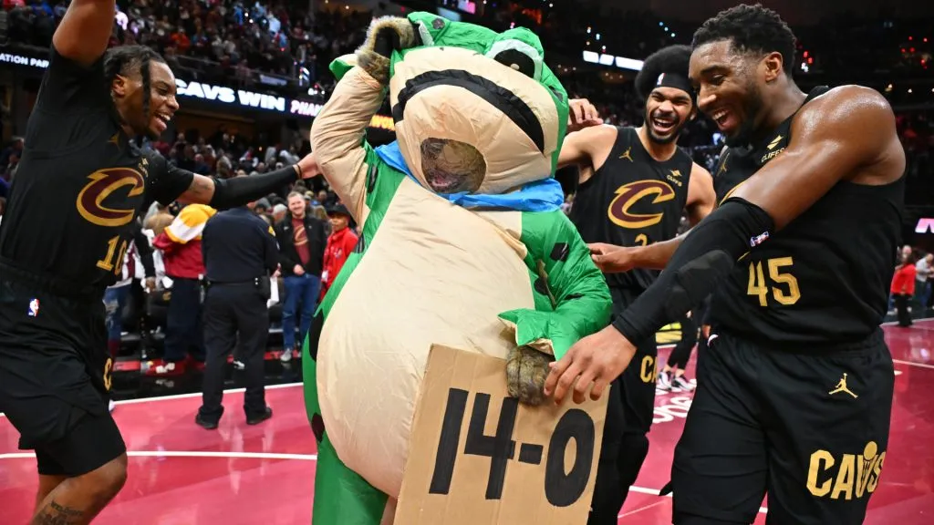 Darius Garland #10 Jarrett Allen #31 and Donovan Mitchell #45 of the Cleveland Cavaliers celebrate with a frog mascot after defeating the Chicago Bulls during of the Emirates NBA Cup game at Rocket Mortgage Fieldhouse. (Jason Miller/Getty Images)