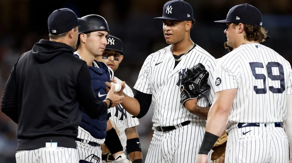 Luis Gil #81 of the New York Yankees gives the ball to Aaron Boone #17 of the New York Yankees against the Boston Red Sox in the fifth inning during game two of a doubleheader at Yankee Stadium on August 17, 2021 in New York City. (Photo by Adam Hunger/Getty Images)
