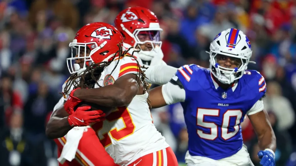 Kareem Hunt #29 of the Kansas City Chiefs runs with the ball against Greg Rousseau #50 of the Buffalo Bills during the third quarter at Highmark Stadium on November 17, 2024 in Orchard Park, New York.