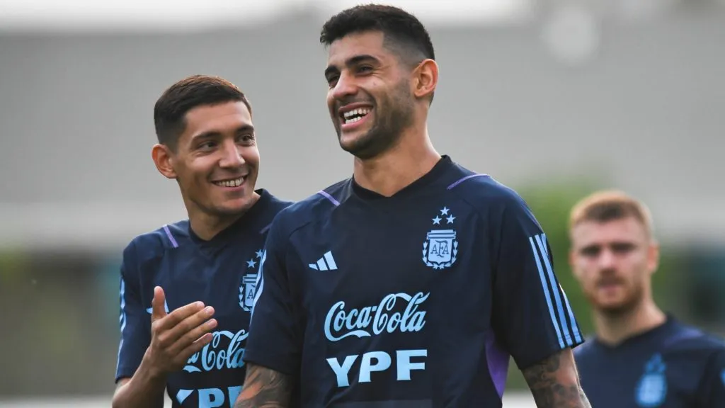 Cristian Romero of Argentina and Nahuel Molina smile during a training session ahead of a Qualifier match against Paraguay at Lionel Messi Training Camp on October 10, 2023 in Ezeiza, Argentina.