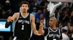 Victor Wembanyama #1 of the San Antonio Spurs and Chris Paul #3 react to a call in action against the Washington Wizards in the second half at Frost Bank Center on November 13, 2024 in San Antonio, Texas.