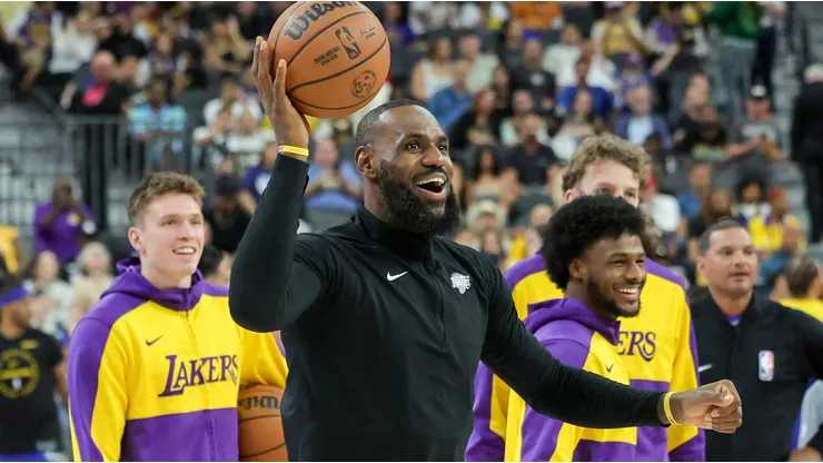 (L-R) Dalton Knecht #4, LeBron James #23 and Bronny James #9 of the Los Angeles Lakers warm up before a preseason game against the Golden State Warriors at T-Mobile Arena at T-Mobile Arena on October 15, 2024 in Las Vegas, Nevada.