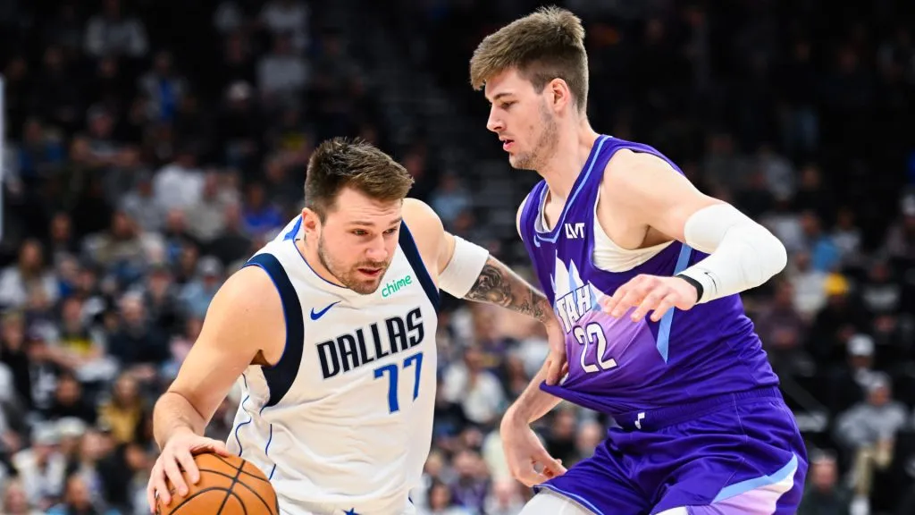 Luka Doncic #77 of the Dallas Mavericks drives into Kyle Filipowski #22 of the Utah Jazz during the first half of a game at Delta Center. Alex Goodlett/Getty Images