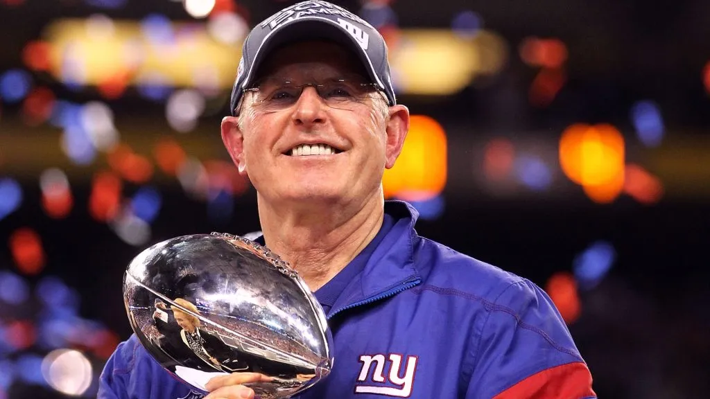 Head coach Tom Coughlin of the New York Giants celebrates with the Vince Lombardi Trophy after defeating the New England Patriots in Super Bowl XLVI at Lucas Oil Stadium on February 5, 2012. (Source: Al Bello/Getty Images)