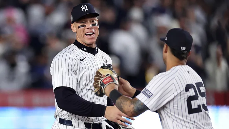 Aaron Judge #99 and Gleyber Torres #25 of the New York Yankees congratulate each other after the yankees defeated the Los Angeles Dodgers 11-4 to win Game Four of the 2024 World Series at Yankee Stadium on October 29, 2024 in the Bronx borough of New York City.