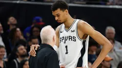 Victor Wembanyama #1 of the San Antonio Spurs is consoled by head coach Gregg Popovich of the San Antonio Spurs during a game against the Denver Nuggets in the first half at Moody Center on March 15, 2024 in Austin, Texas.