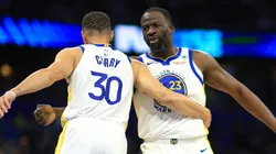 Stephen Curry #30 and Draymond Green #23 of the Golden State Warriors shake hands during a game against the Orlando Magic at Kia Center on March 27, 2024 in Orlando, Florida.