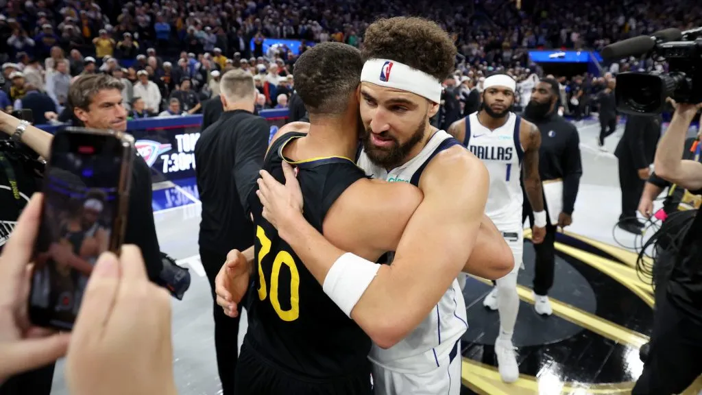 Thompson and Curry hugging