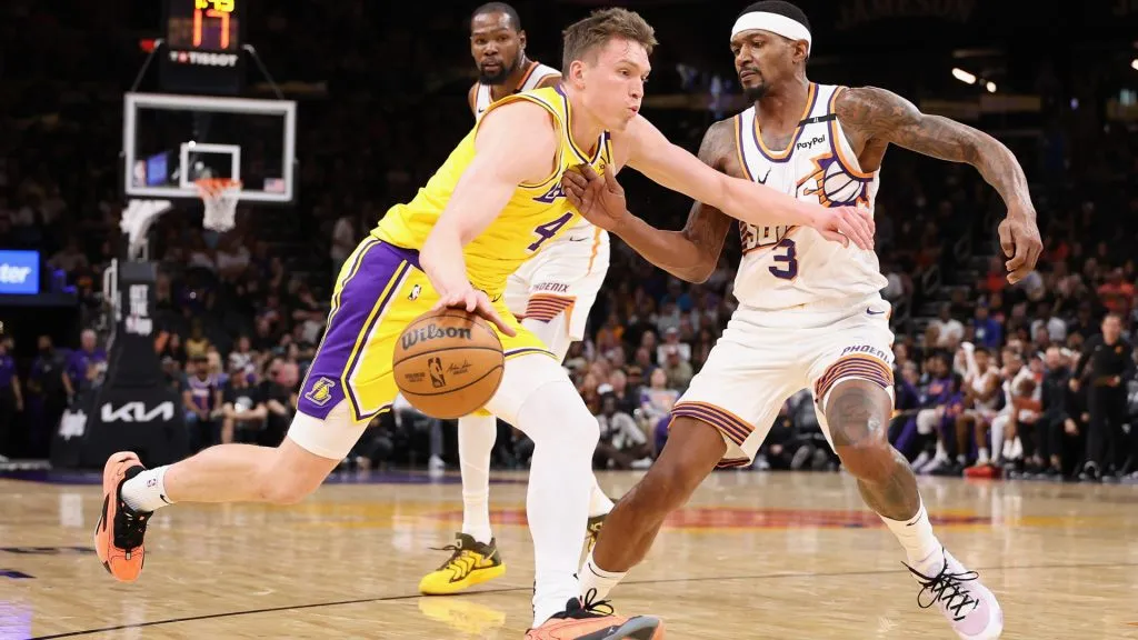 Dalton Knecht #4 of the Los Angeles Lakers drives the ball against Bradley Beal #3 of the Phoenix Suns during the first half of the preseason NBA game at Footprint Center. Christian Petersen/Getty Images