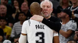 Chris Paul #3 of the San Antonio Spurs gets a hug from Head coach Gregg Popovich after an assist against the Houston Rockets in the first half at Frost Bank Center on October 26, 2024 in San Antonio, Texas.