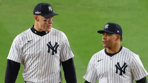 Juan Soto #22 of the New York Yankees jokes with Aaron Judge #99 during the 4th inning of Game One of the American League Championship Series against the Cleveland Guardians at Yankee Stadium on October 14, 2024 in New York City.